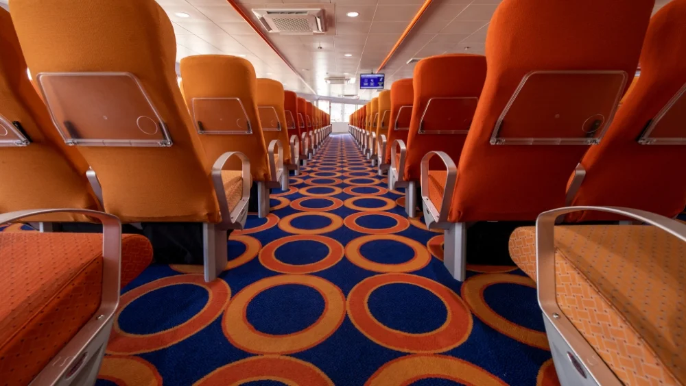 Passenger area with seating on both sides of the aisle on the Bentago Express